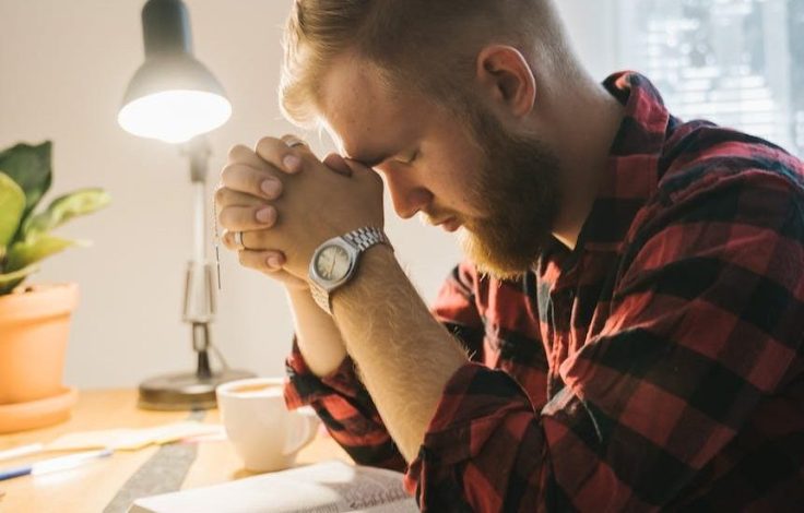 a bearded man praying